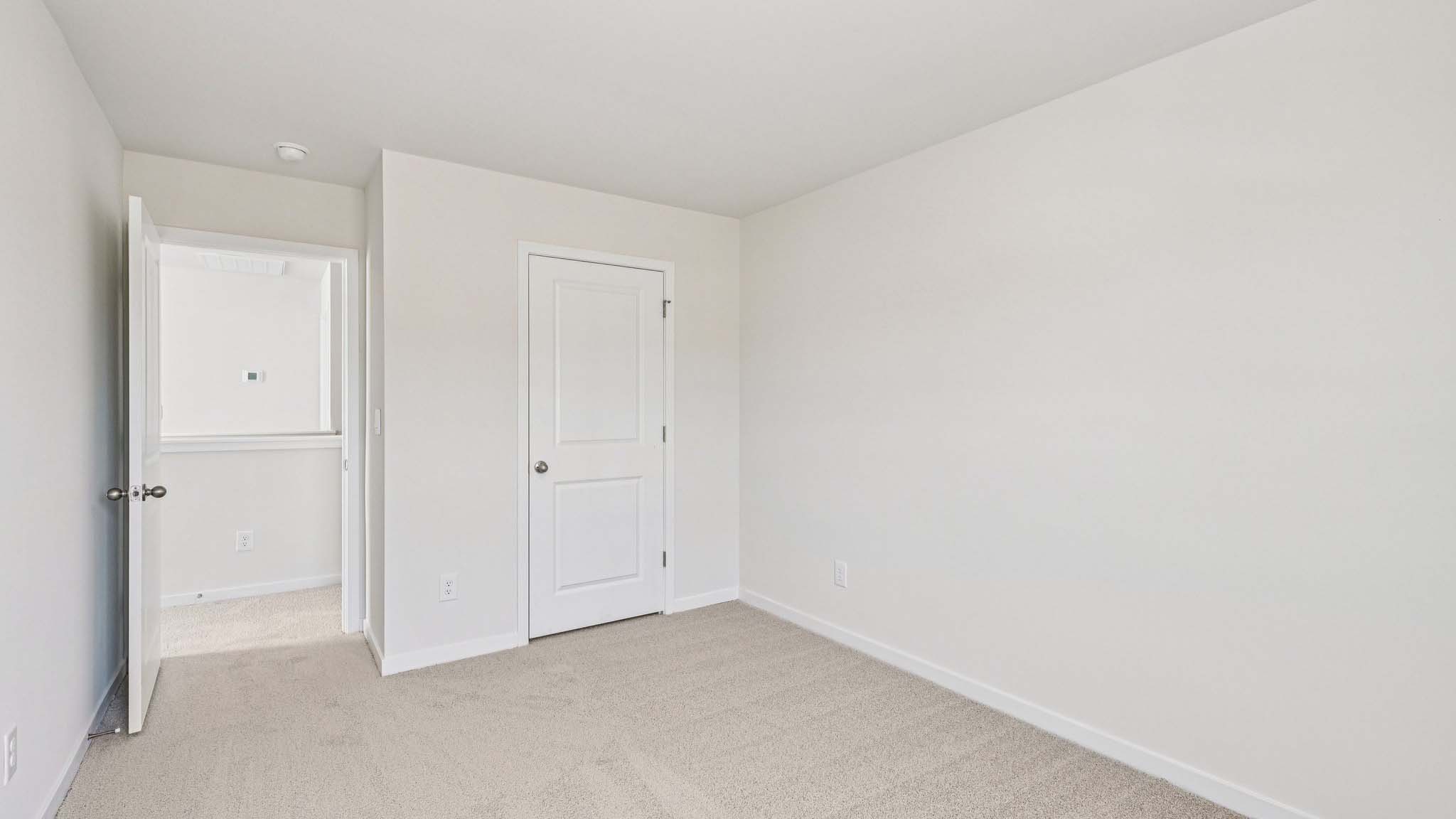 Carpeted bedroom with window