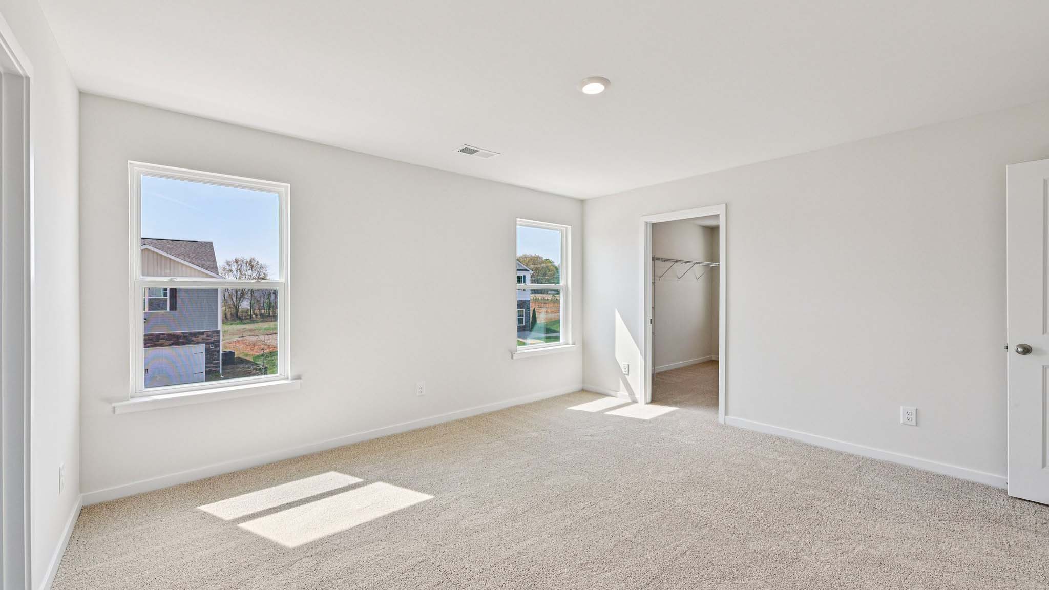 Carpeted bedroom with window