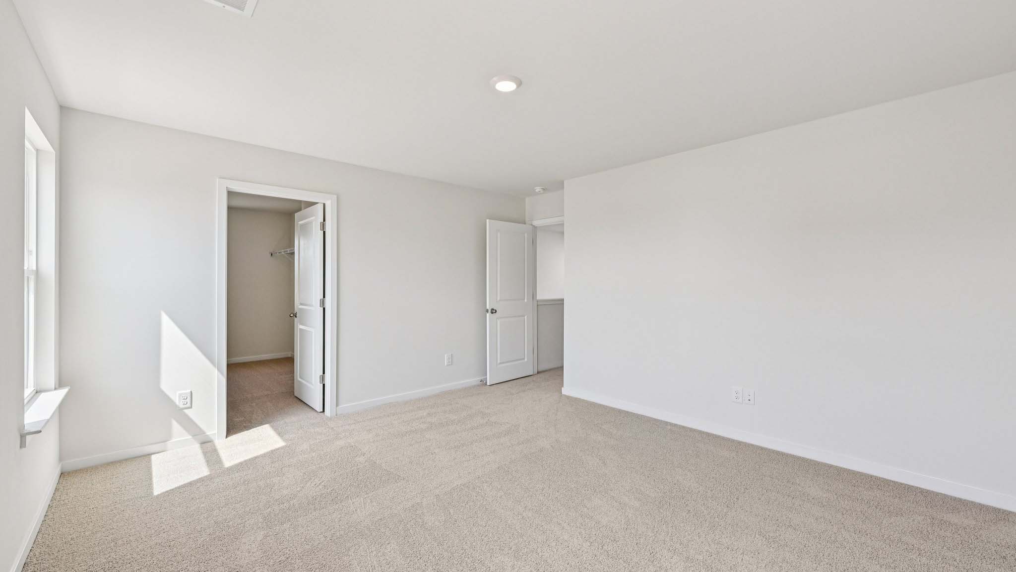 Carpeted bedroom with window