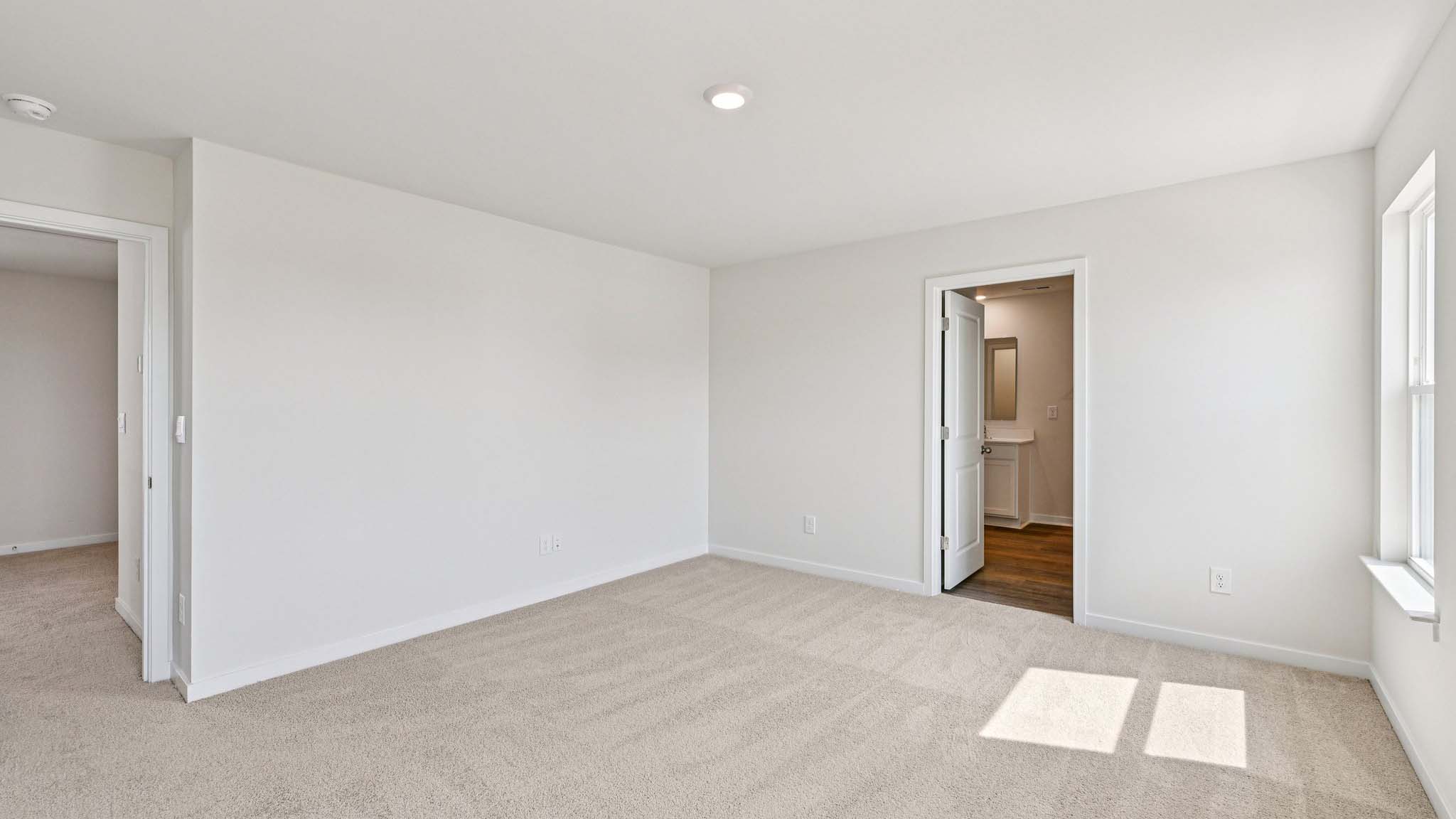 Carpeted bedroom with window