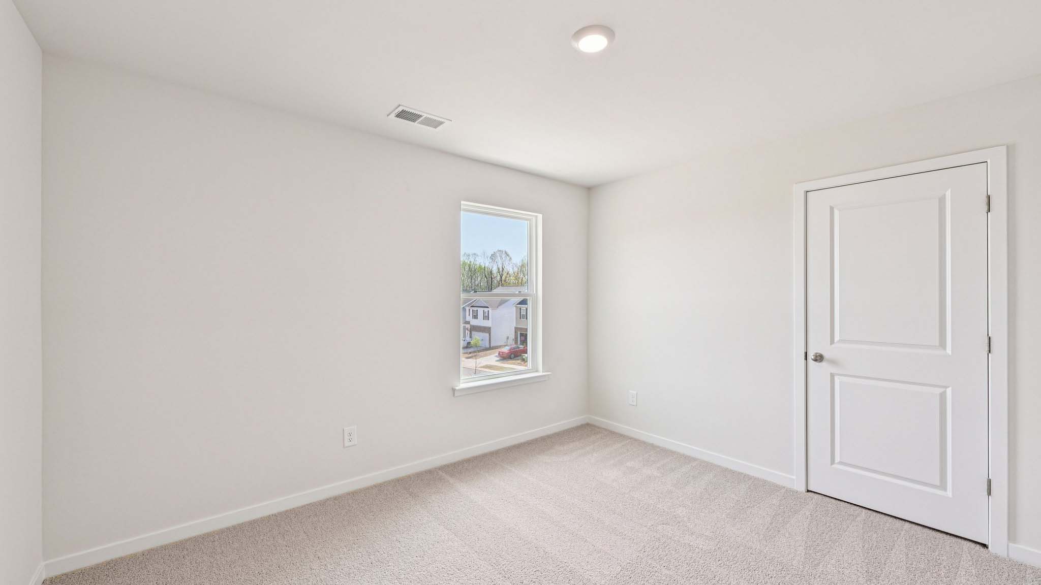 Carpeted bedroom with window