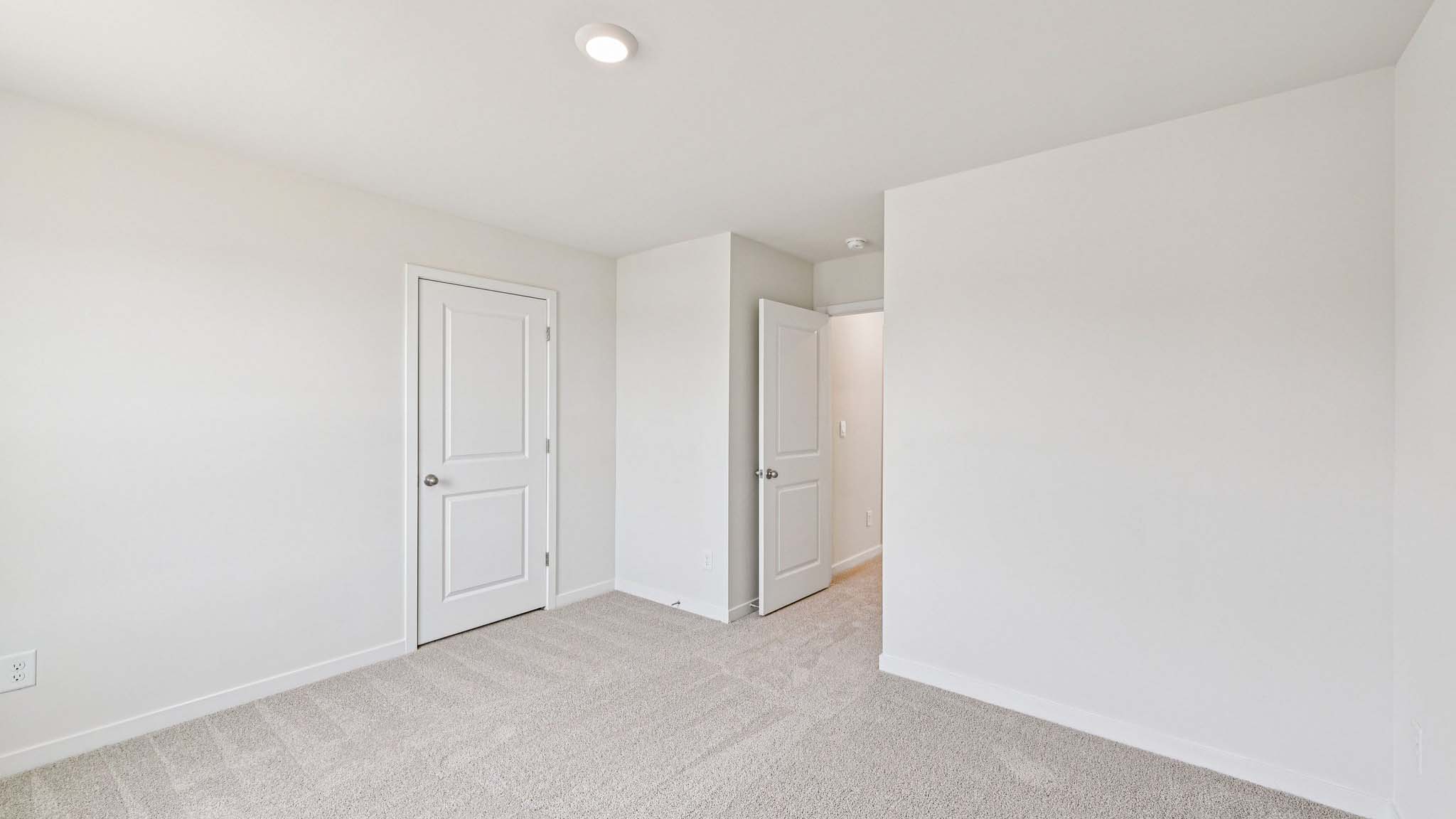Carpeted bedroom with window