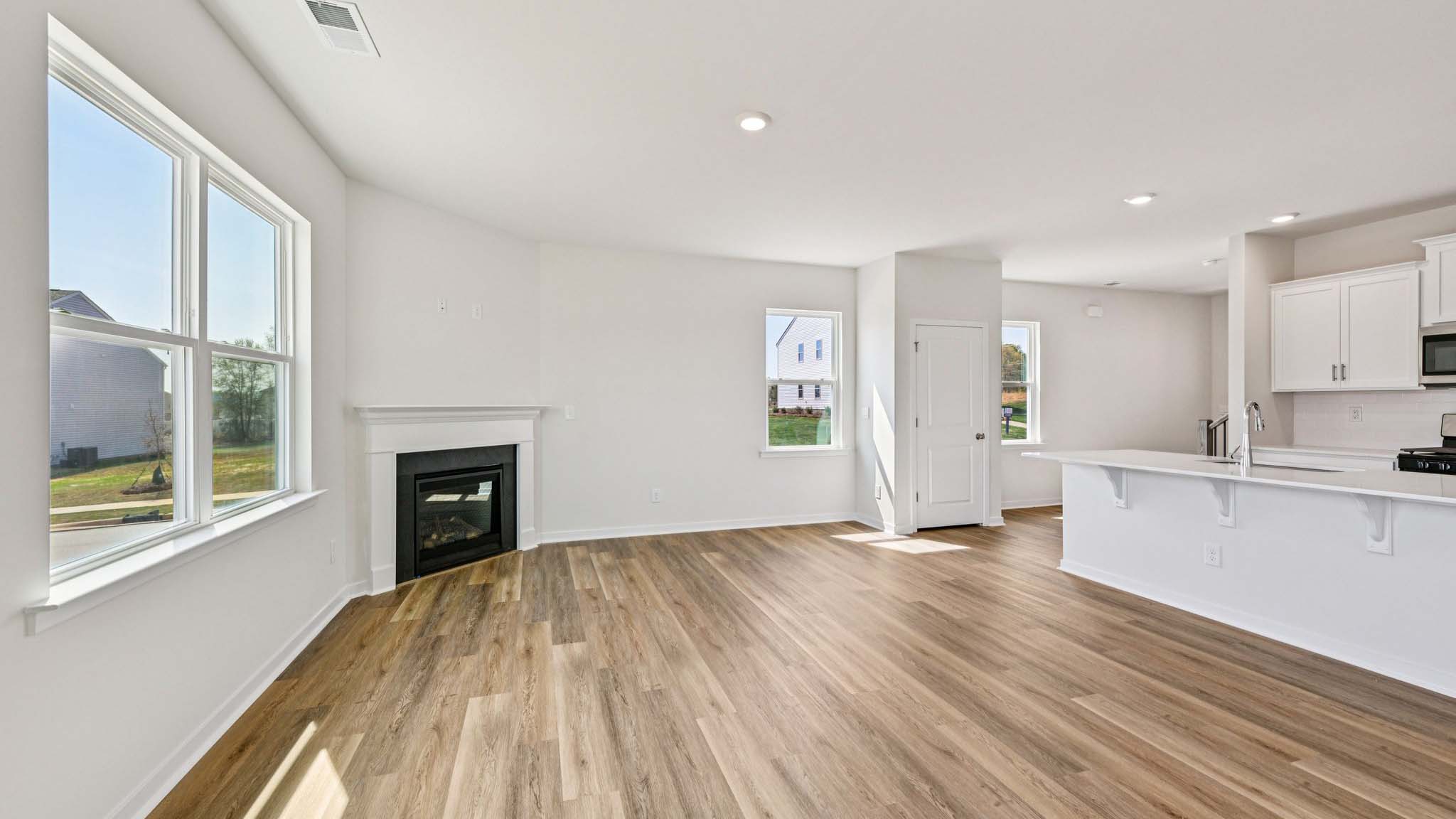 Spacious family room with windows and fireplace