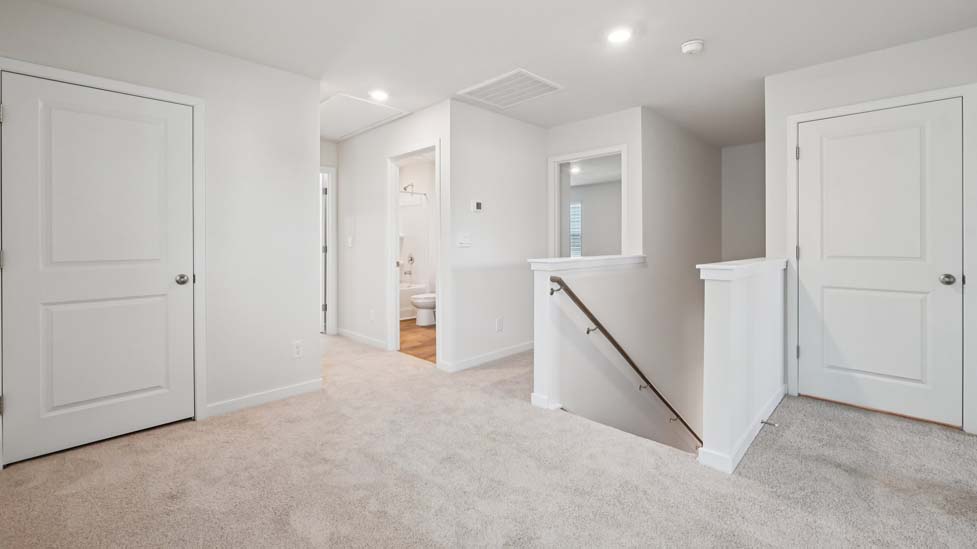 Carpeted loft space atop stairs