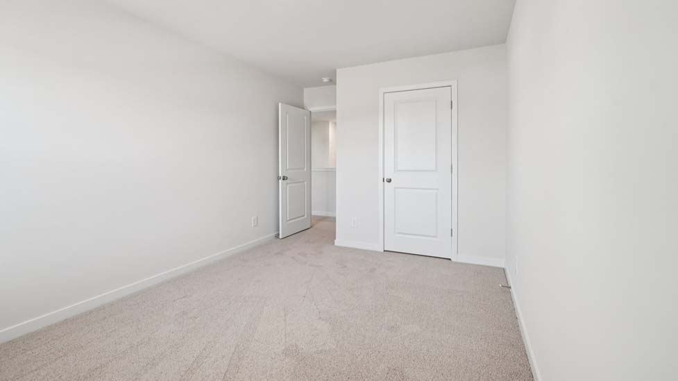 Carpeted bedroom with window