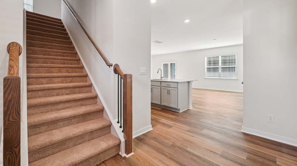 Welcoming foyer with view of front door and stairs