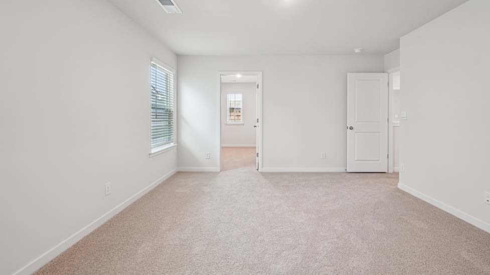 Carpeted bedroom with window