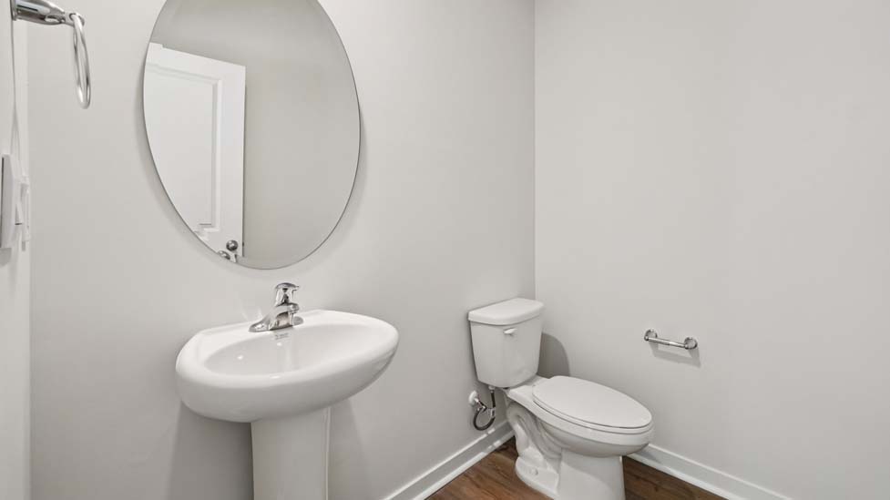 Powder bathroom with small sink and toilet
