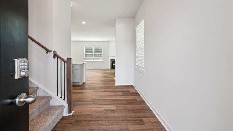 Welcoming foyer with view of front door and stairs
