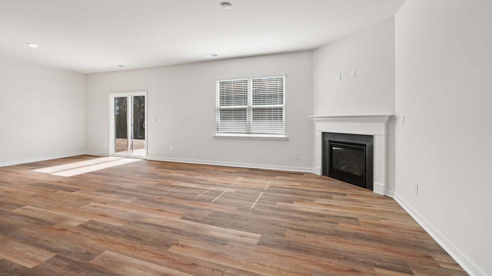 Spacious family room with windows and fireplace