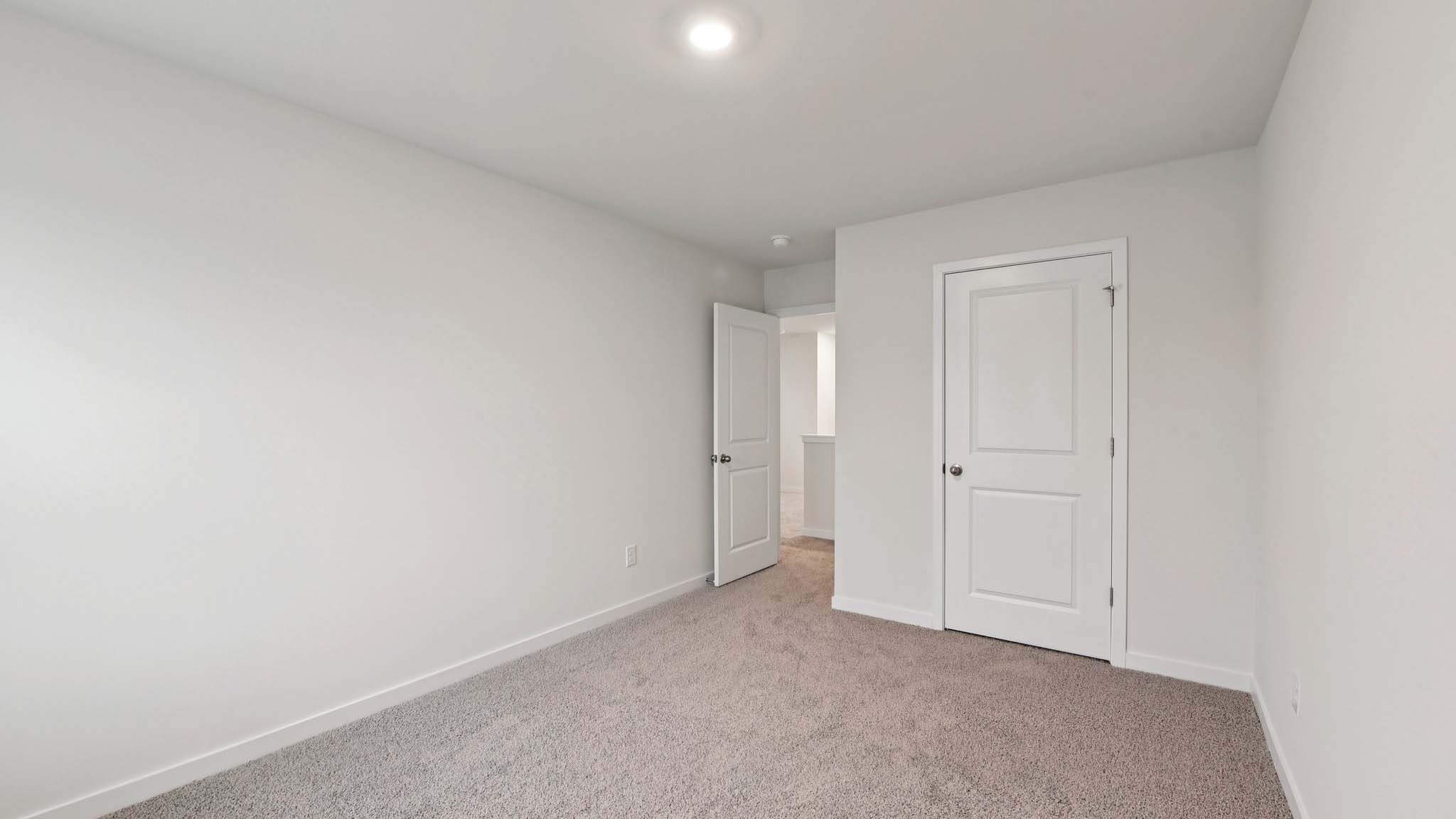 Carpeted bedroom with windows