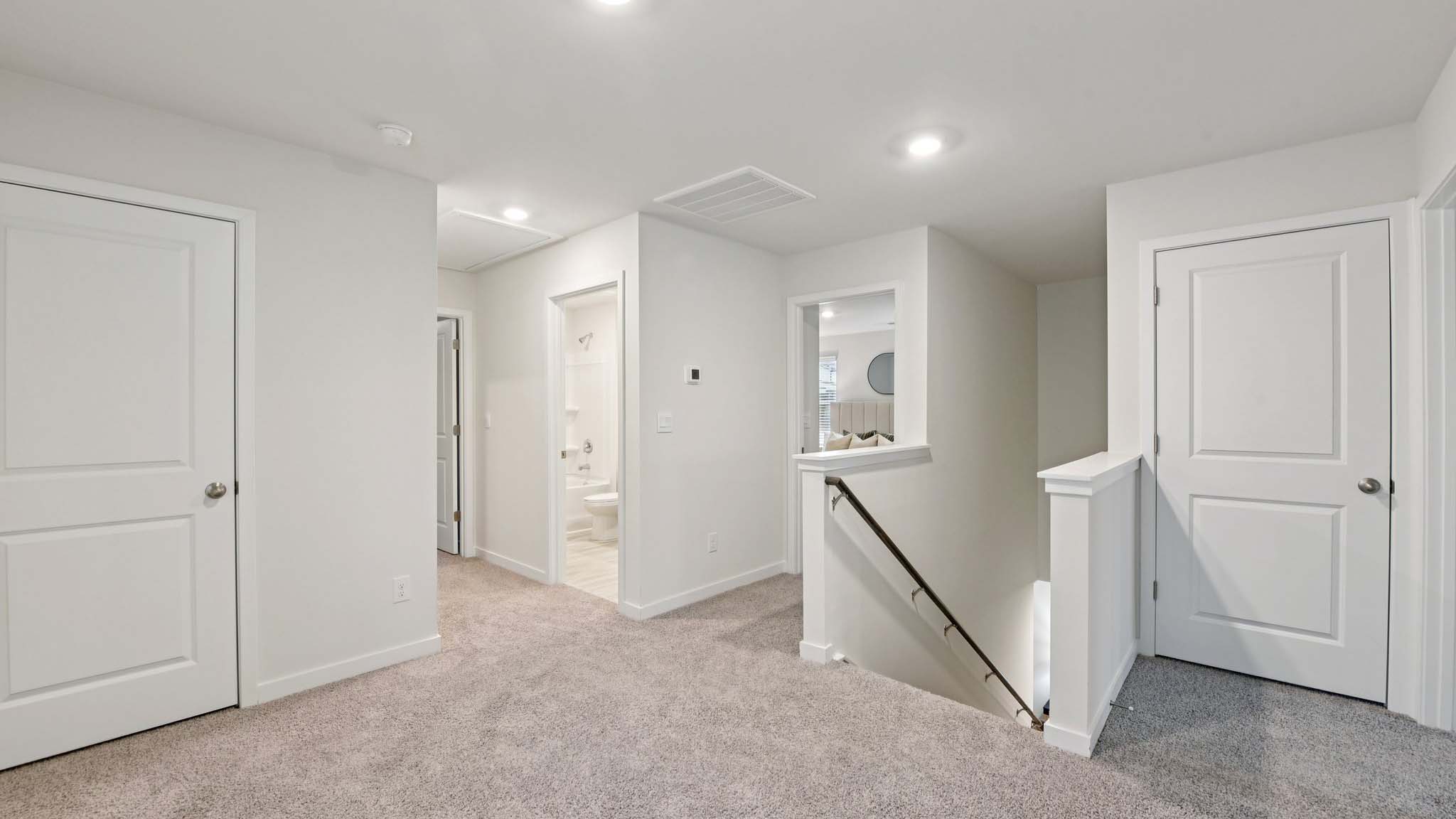 Carpeted bedroom with windows