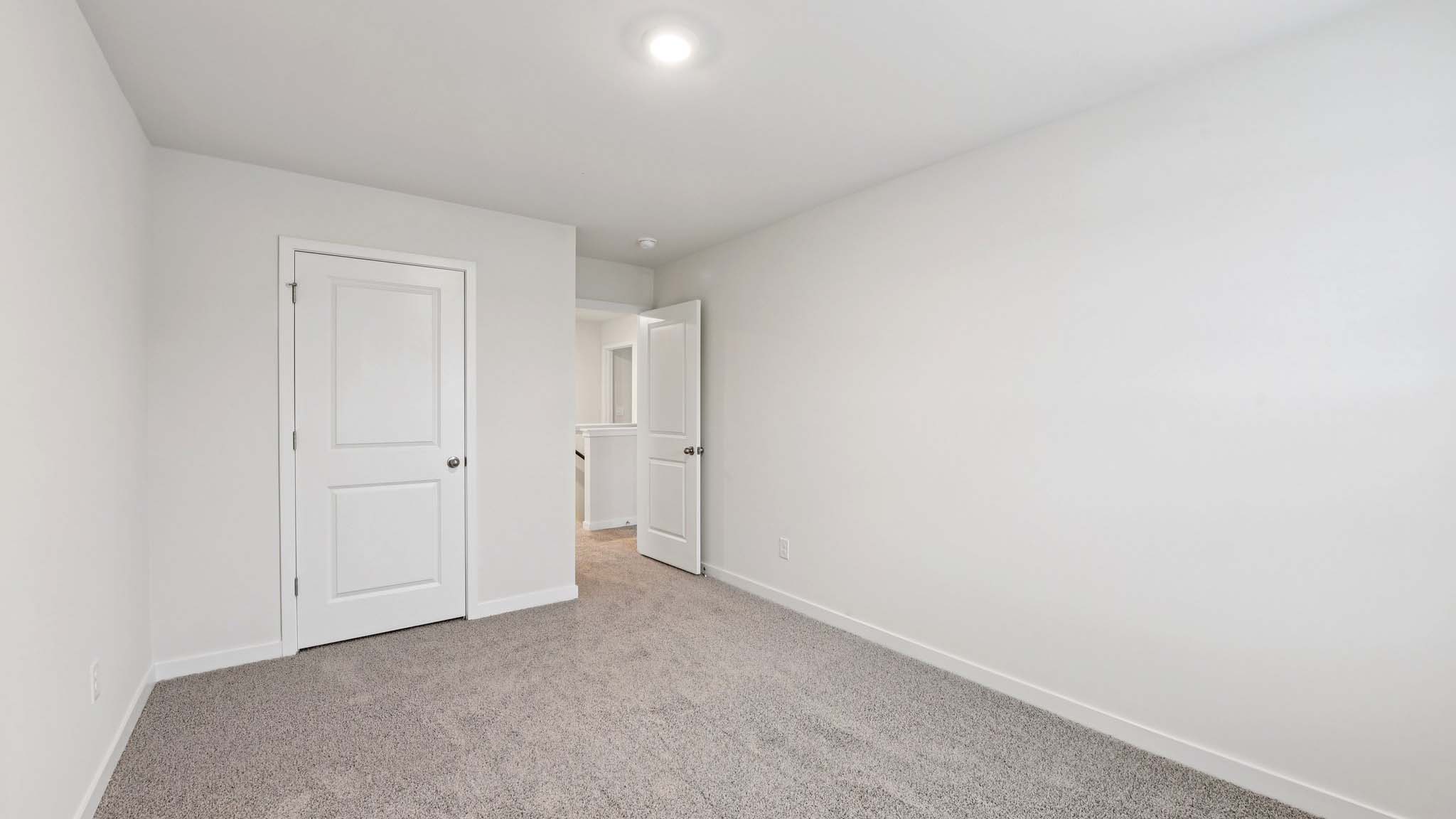 Carpeted bedroom with windows