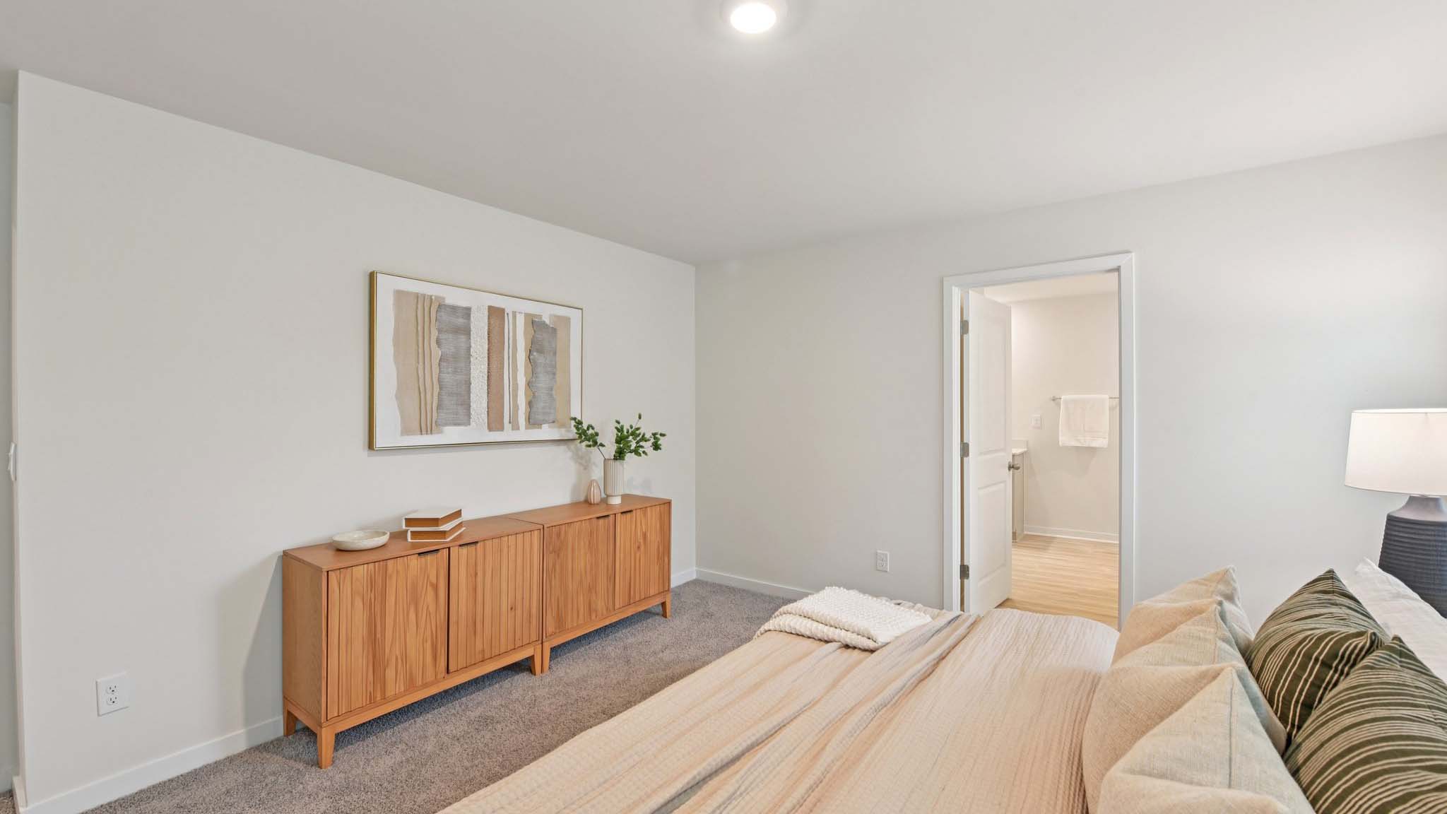 Primary carpeted bedroom with windows