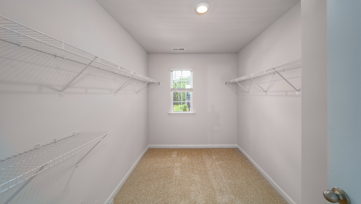 Primary bedroom carpeted walkin closet