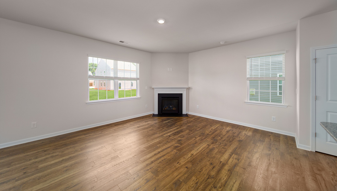 Spacious family room with windows and fireplace