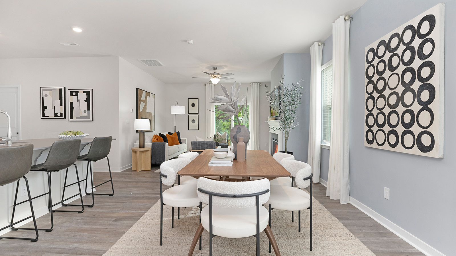 Dining area beside kitchen with large windows