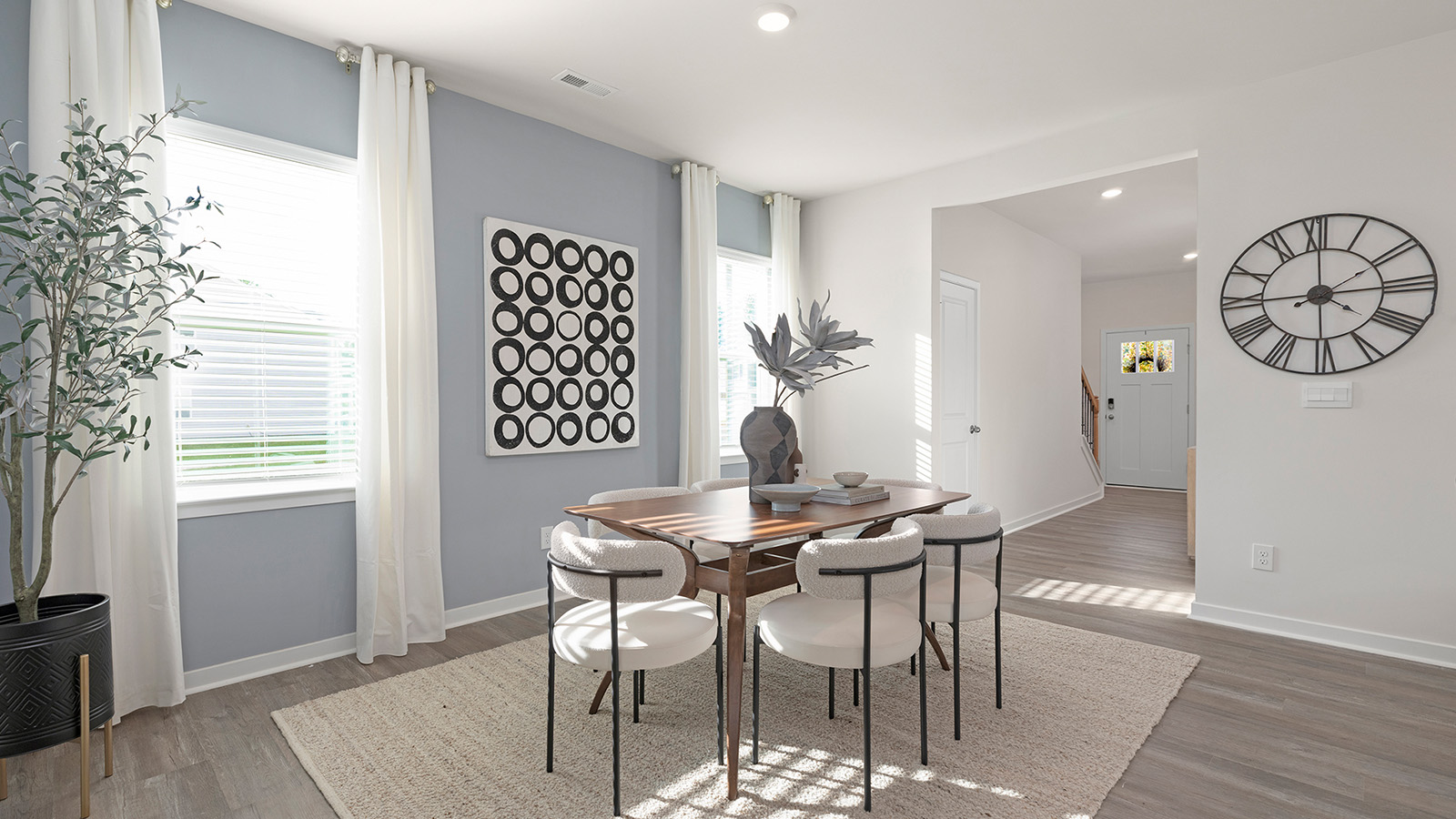 Dining area beside kitchen with large windows