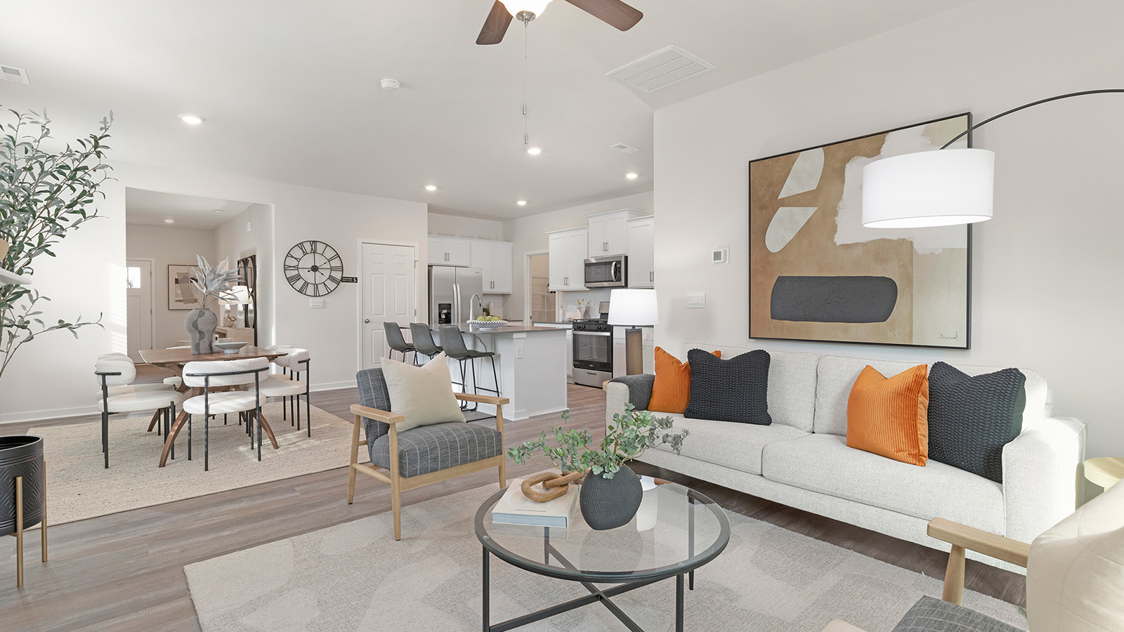 Open living room beside kitchen and dining room with direplace and large windows