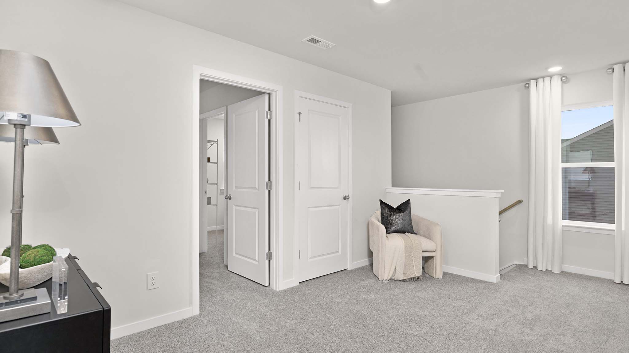 Carpeted bedroom with large window