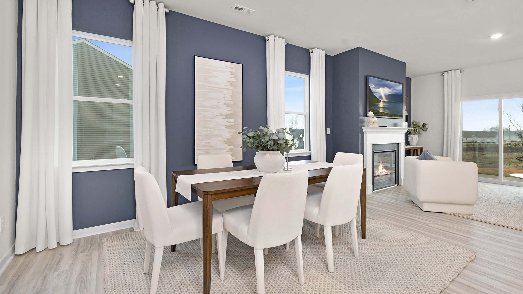Dining area beside kitchen with large windows