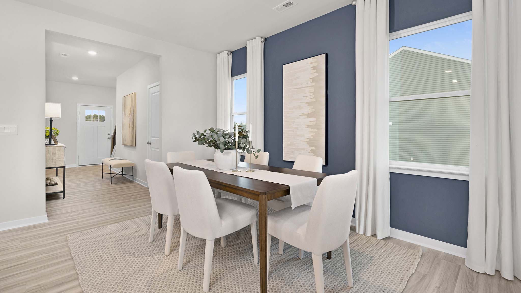 Dining area beside kitchen with large windows