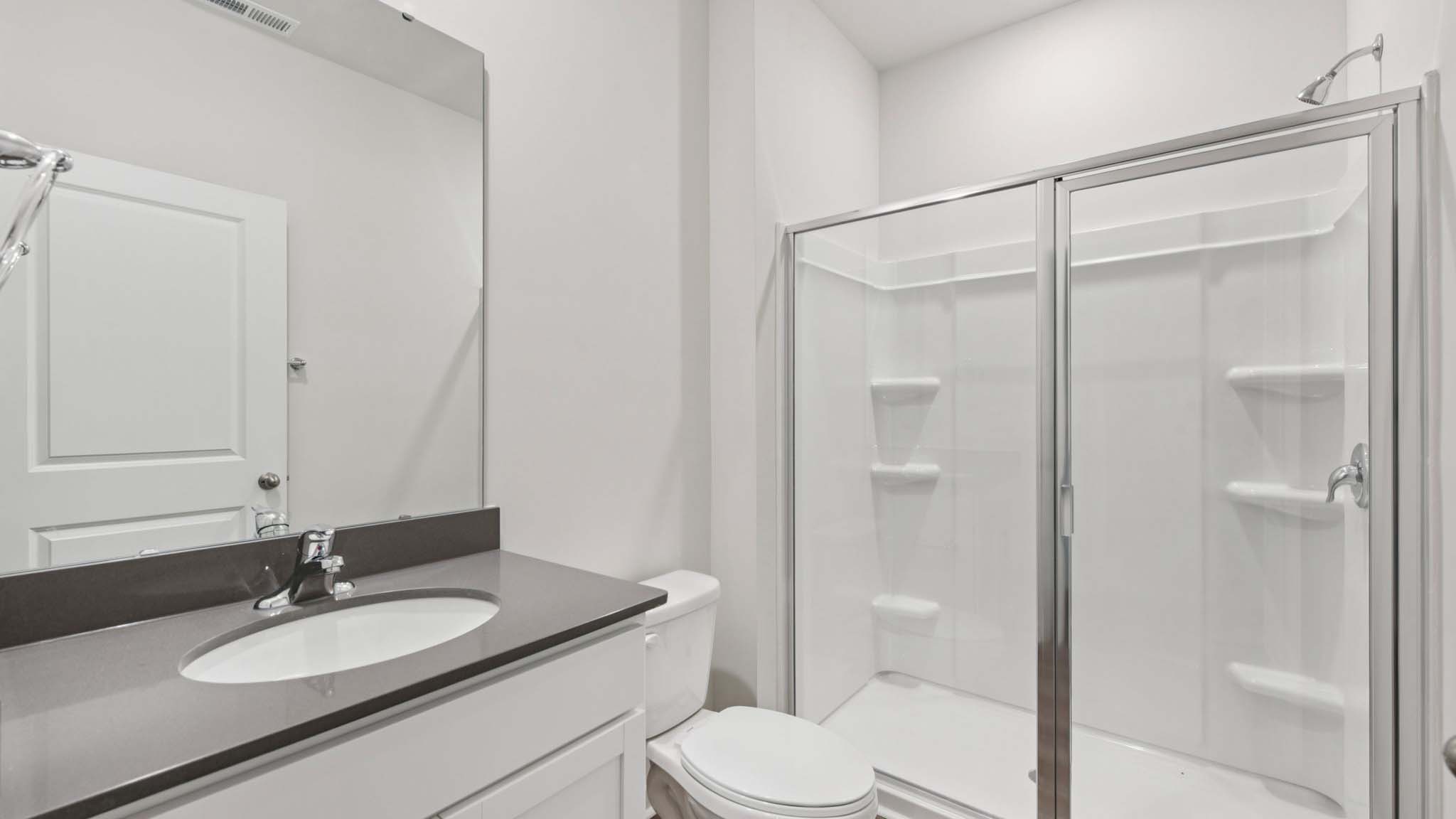 Bathroom with standing glass shower