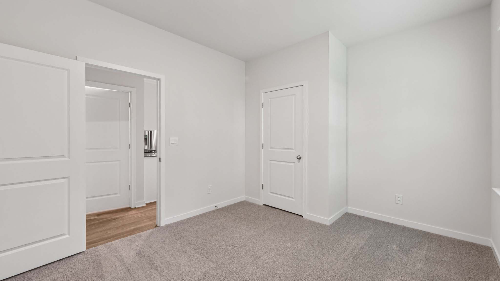 Carpeted bedroom with large window