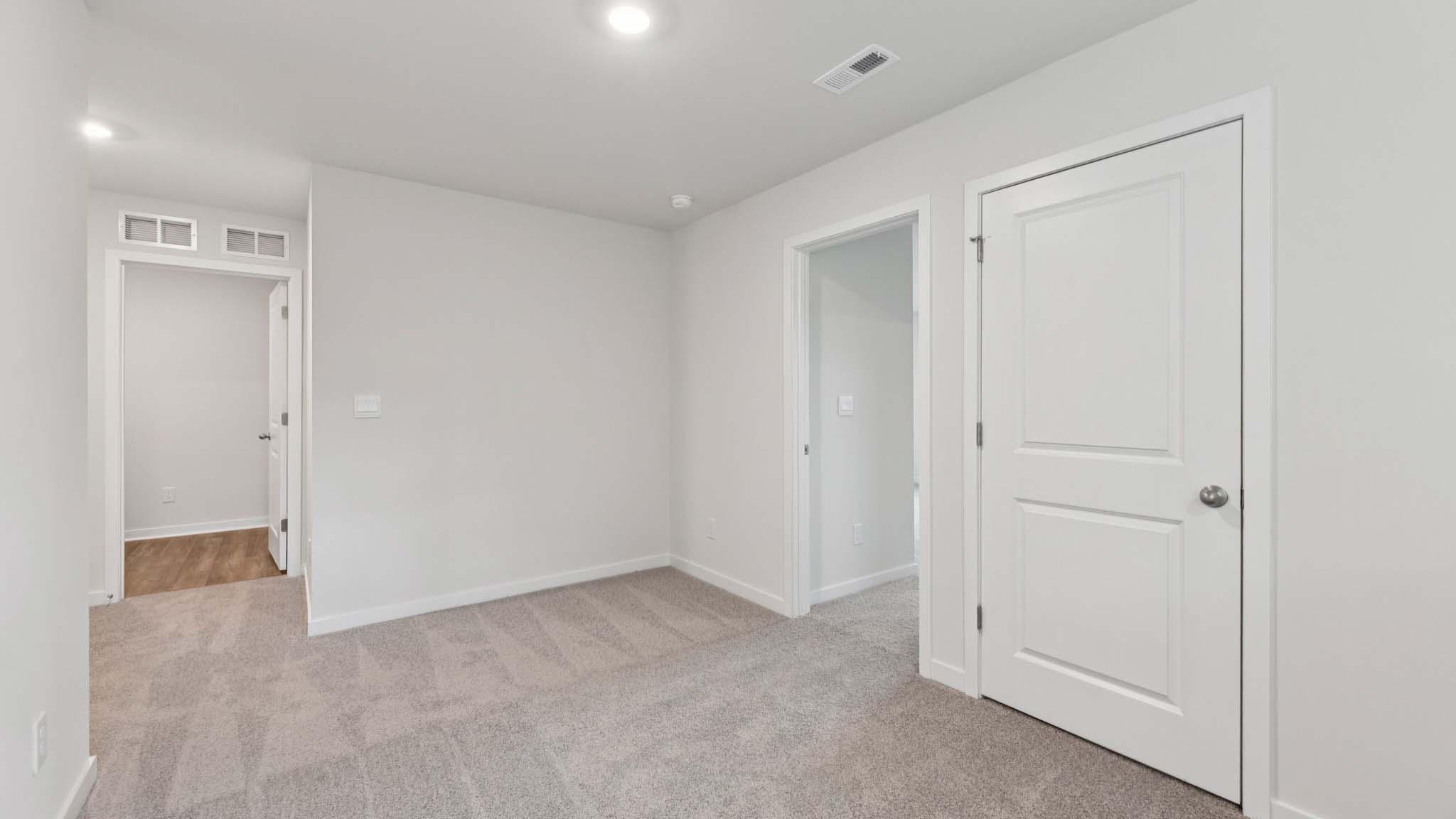 Carpeted bedroom with large window