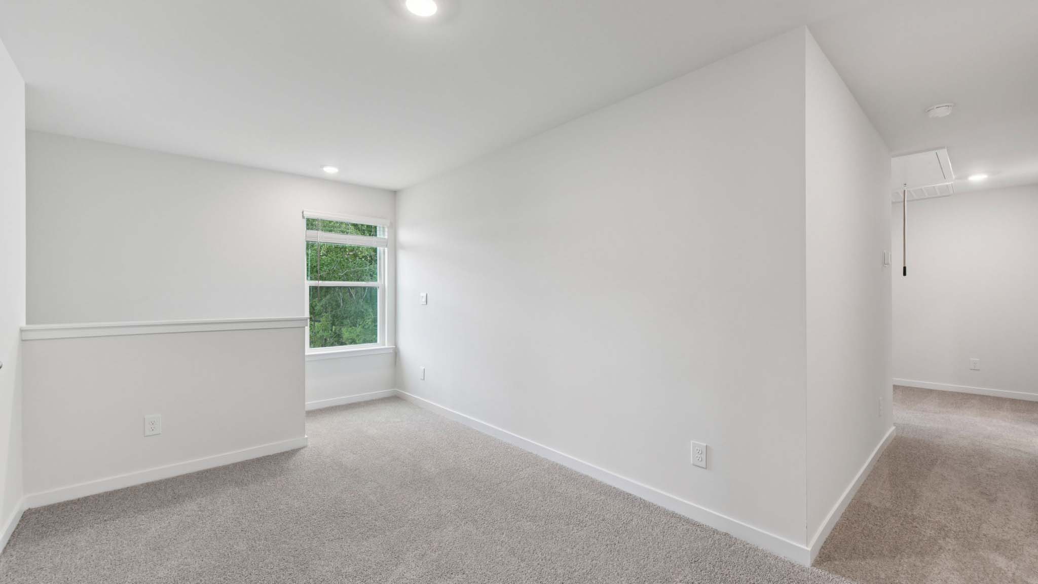 Carpeted loft with small window