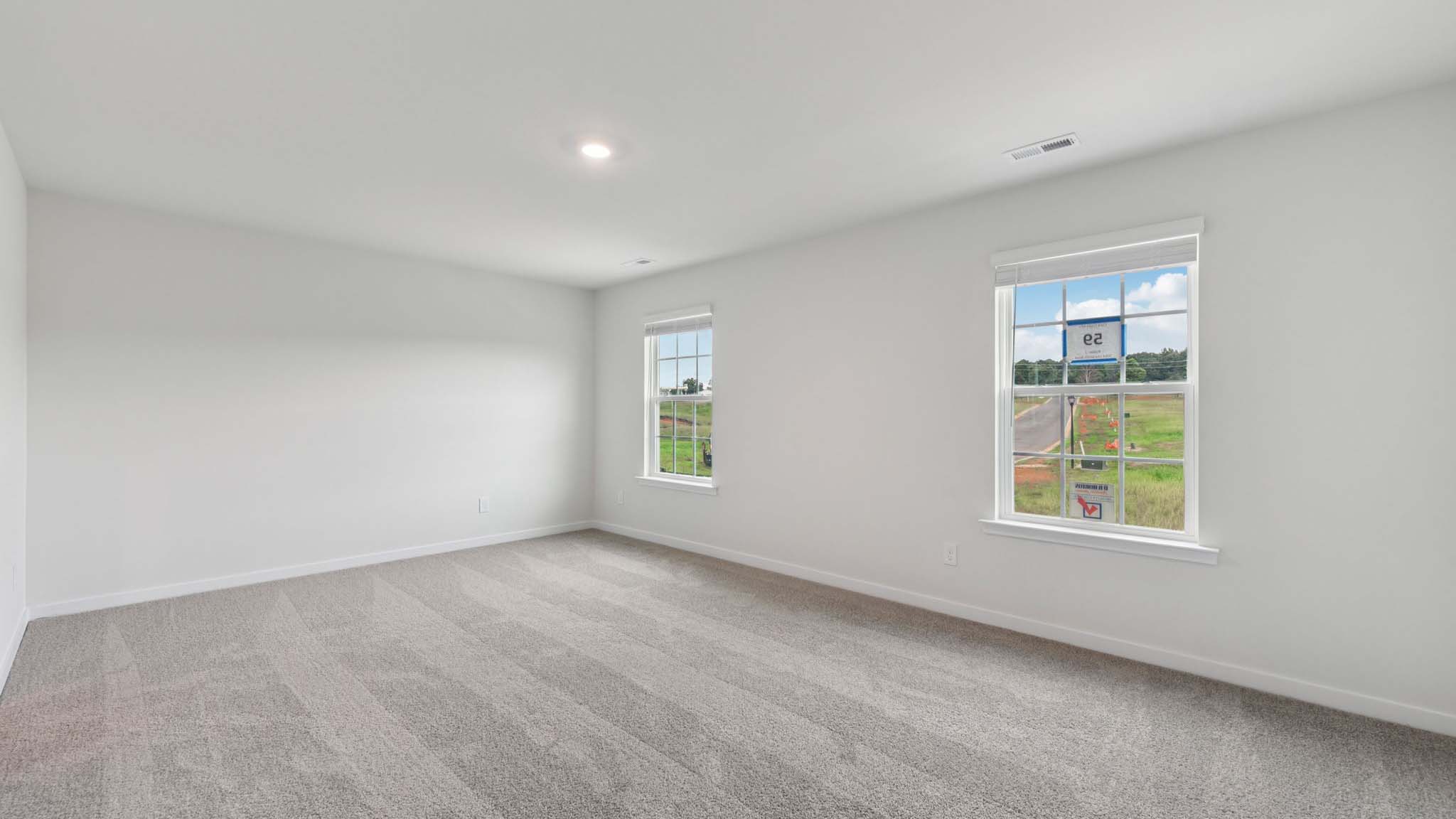 Carpeted bedroom with large window