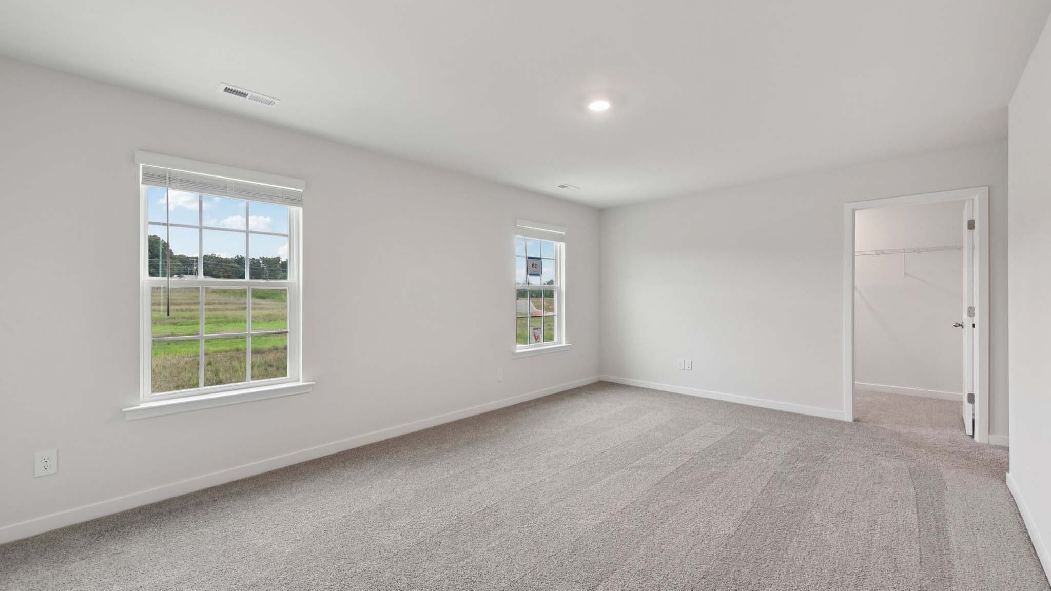 Carpeted bedroom with large window