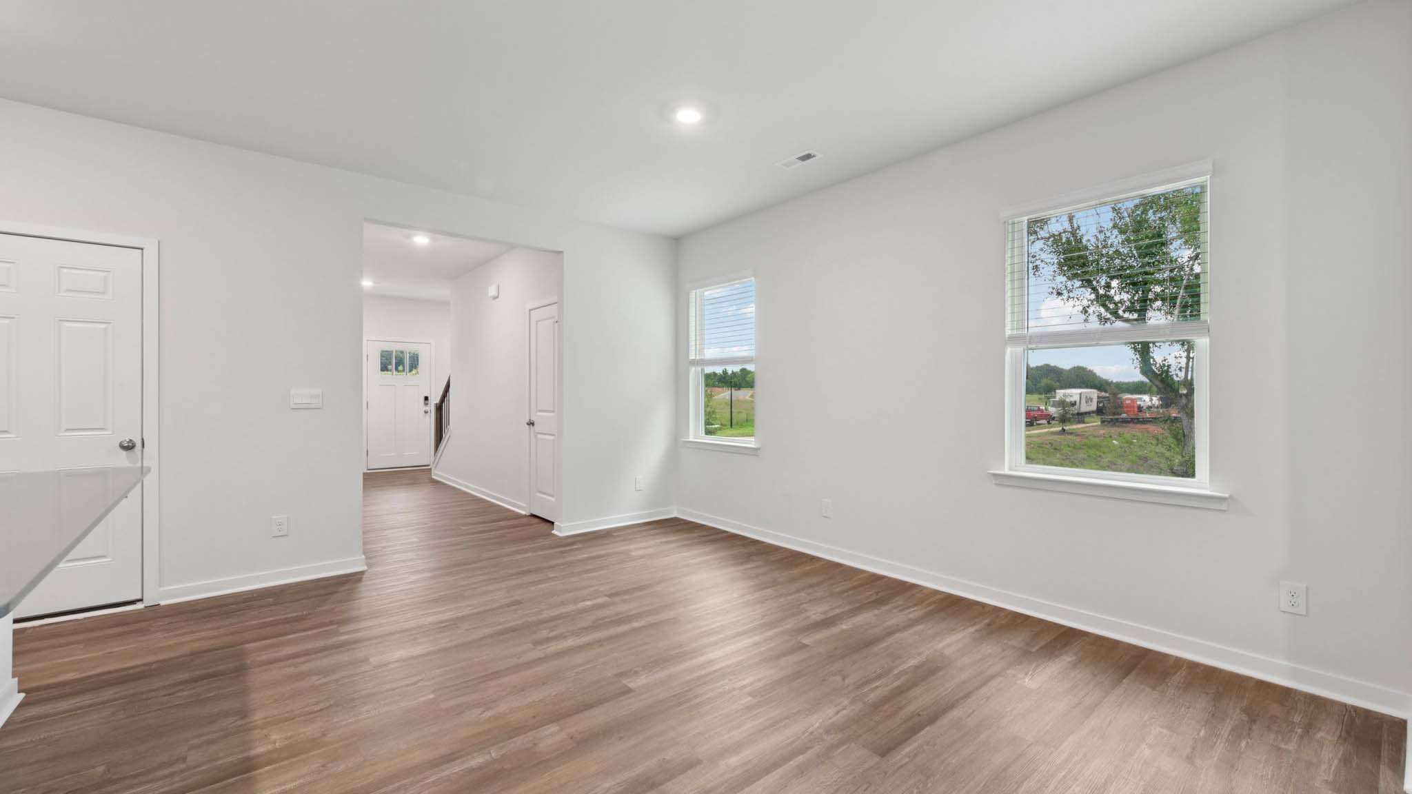 Dining area beside kitchen with large windows