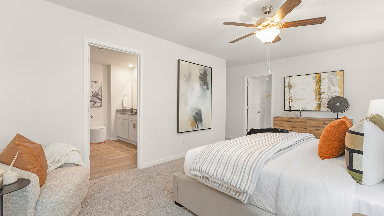 Primary bedroom with beige carpet and two large windows