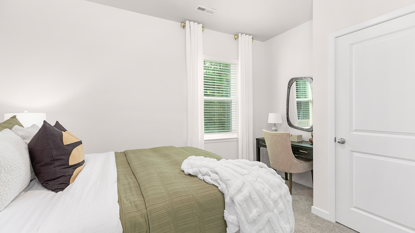 Carpeted bedroom with large window