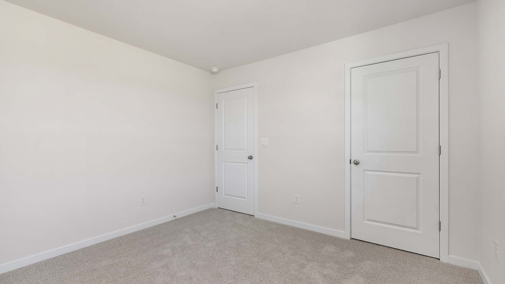 Carpeted bedroom with large window