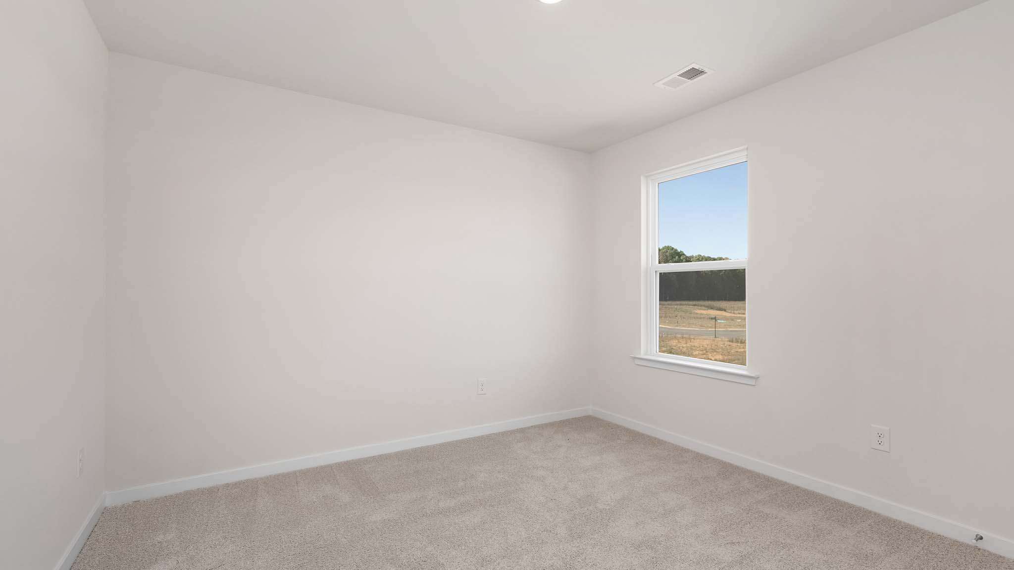 Carpeted bedroom with large window