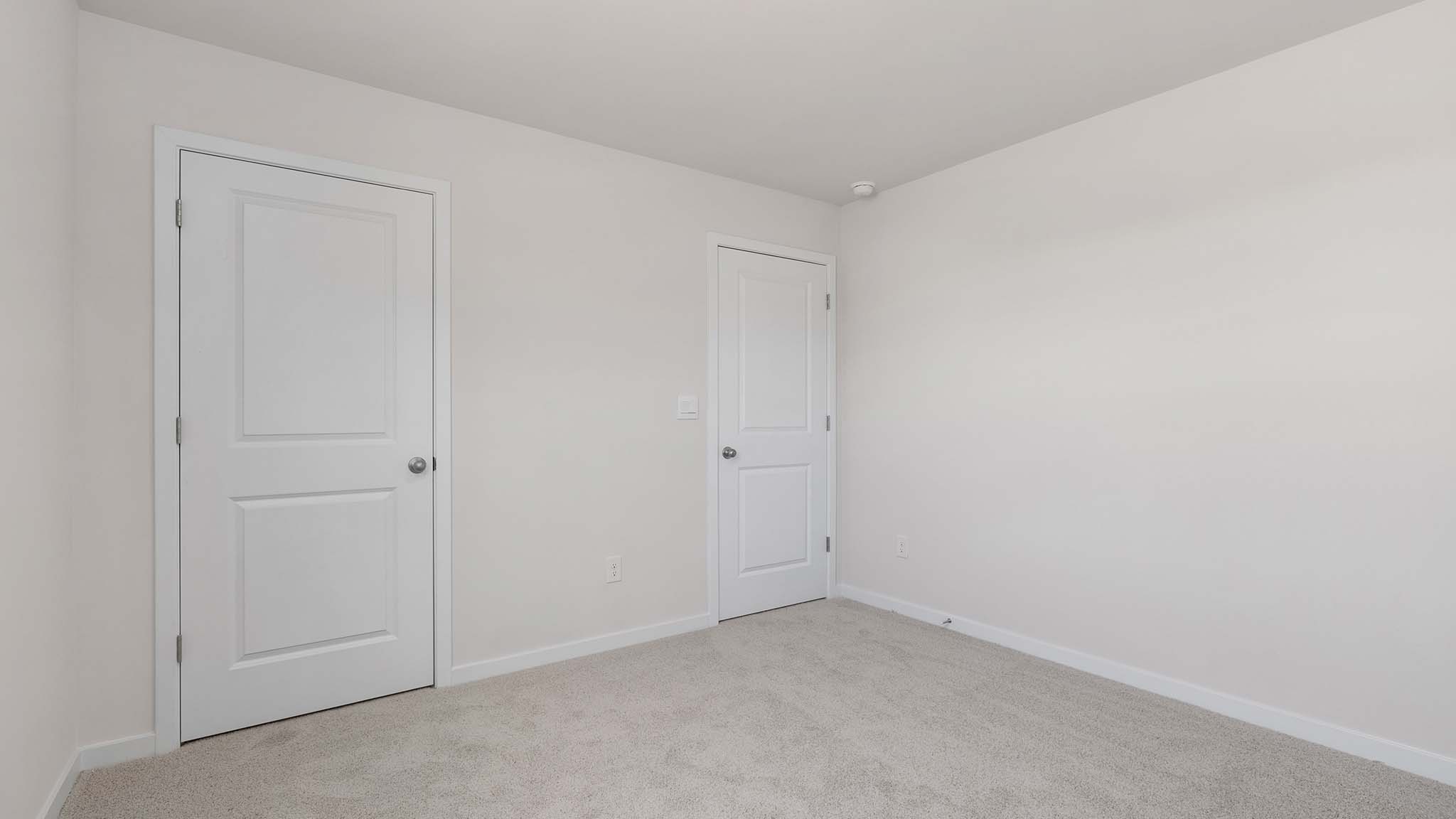 Carpeted bedroom with large window