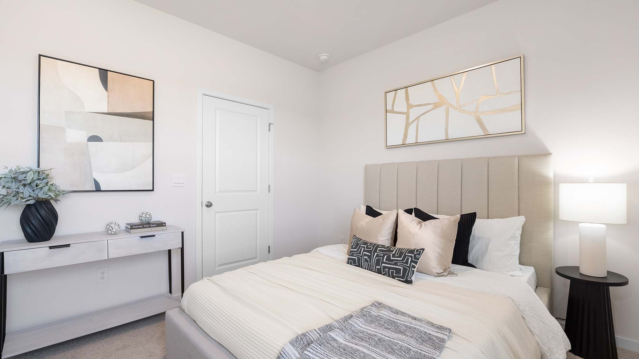 Primary bedroom with beige carpet and two large windows