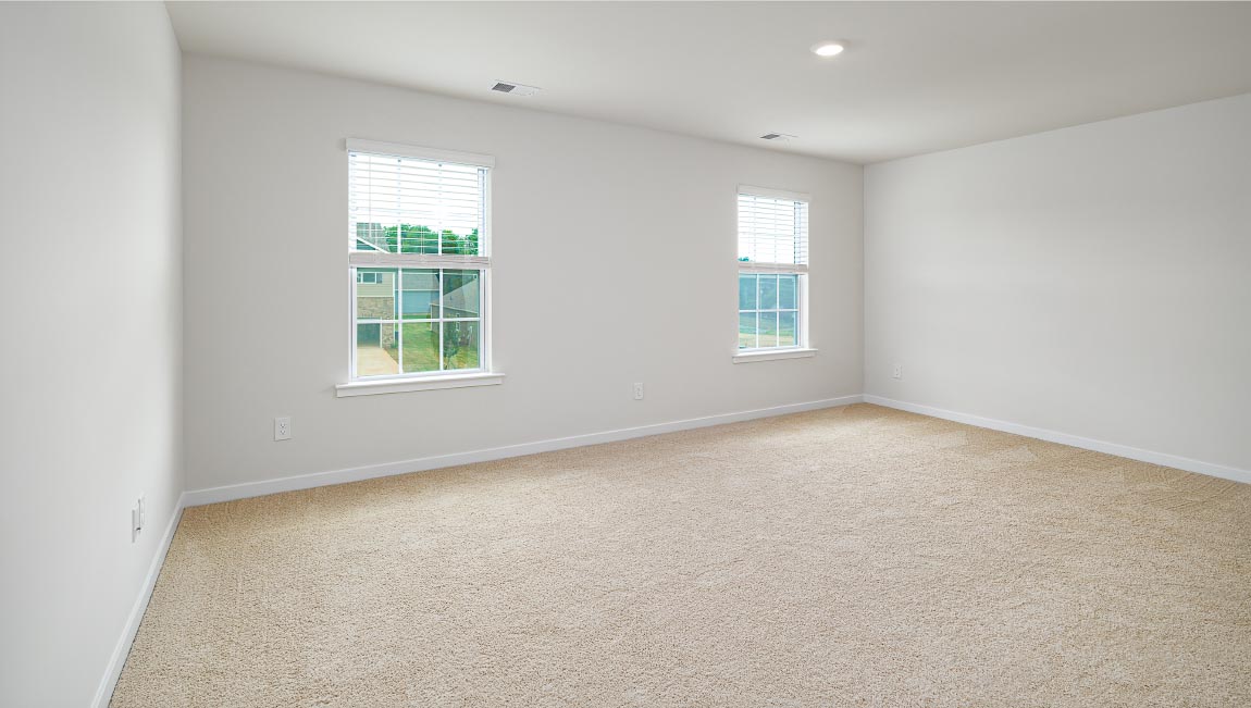 Primary bedroom with two large windows