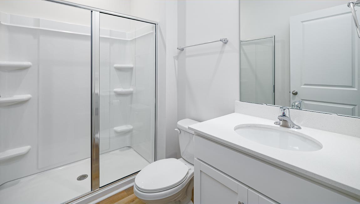 Bathroom with white cabinets and standing glass door shower