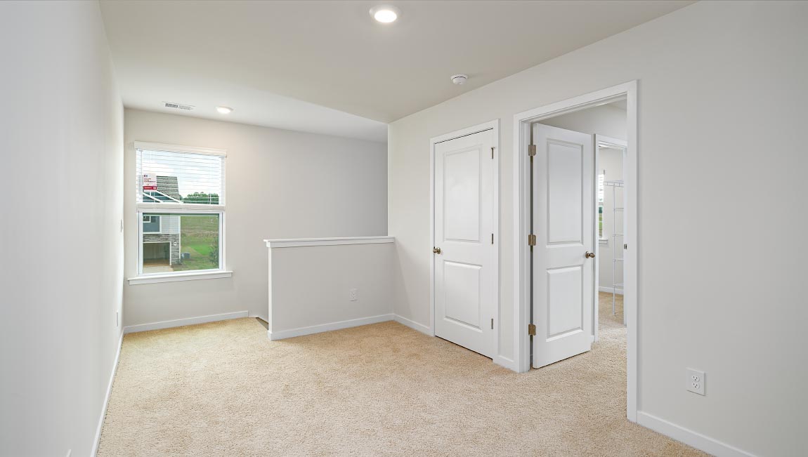 Loft with carpet and large window