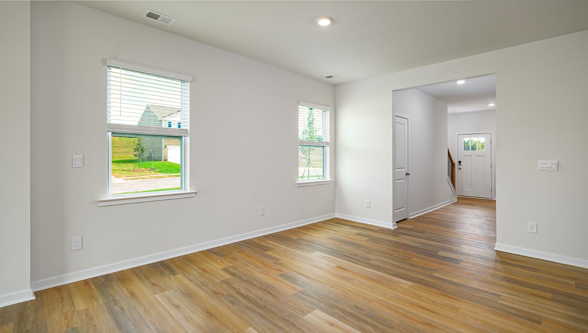 Dining space beside kitchen and living room with large window