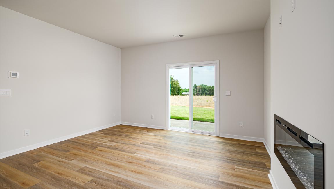 Living room with electric fireplace and sliding glass back door