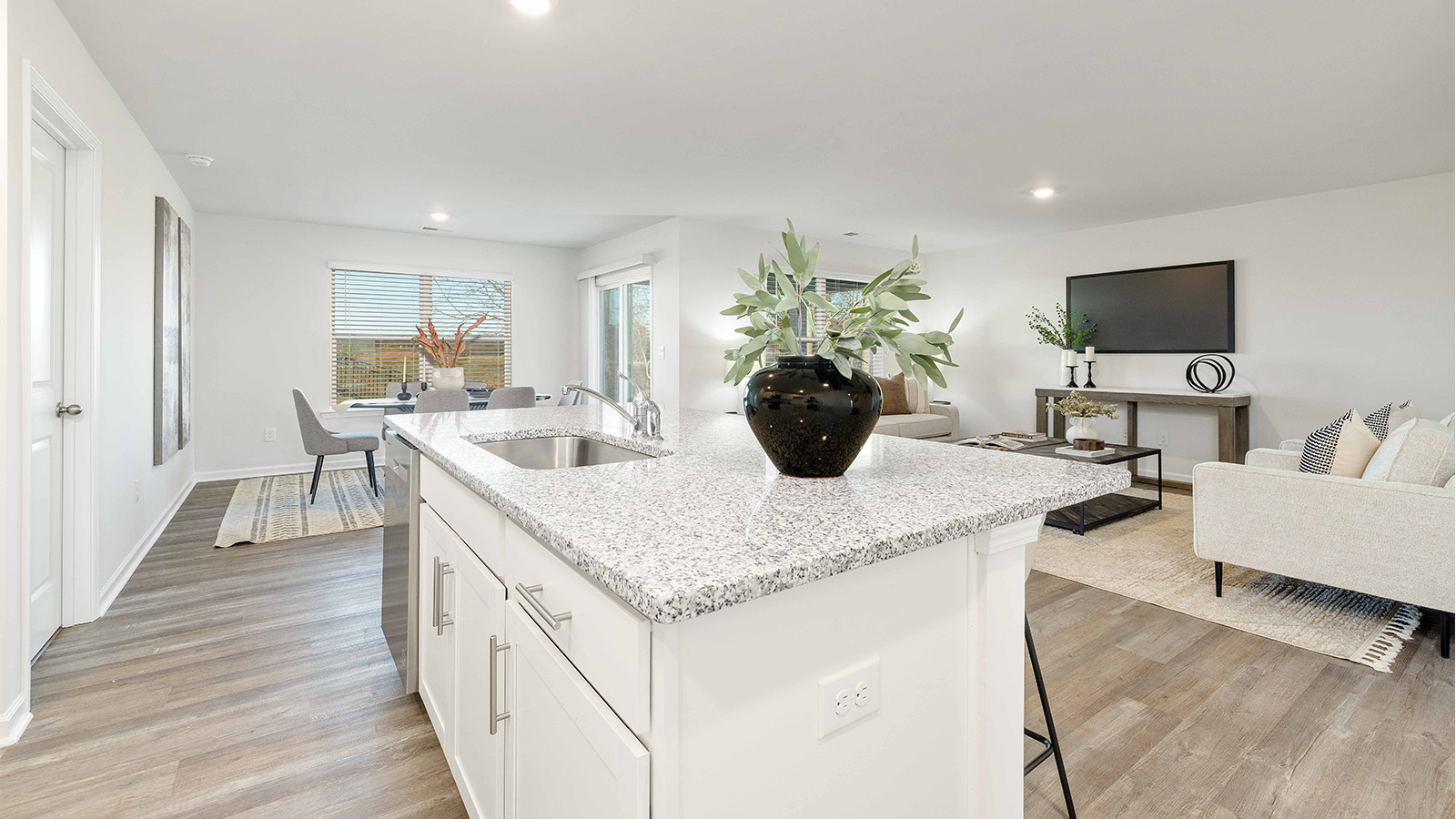 kitchen and island with white cabinets and stainless steel appliances