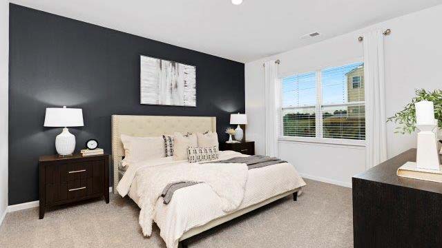 carpeted bedroom with small window