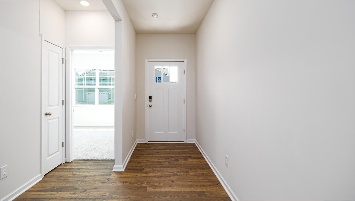Welcoming foyer with wood floors
