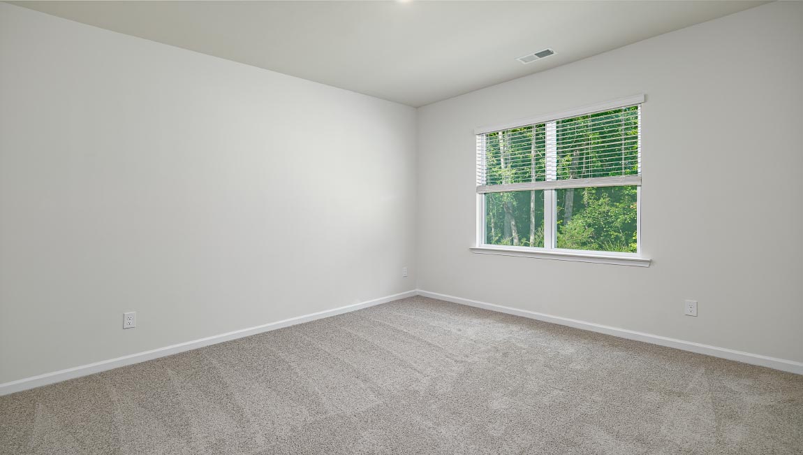 Carpeted bedroom with large window