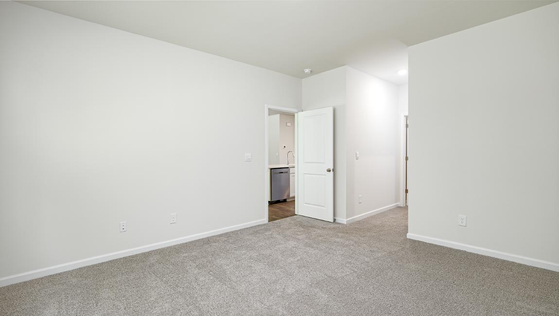 Carpeted bedroom with large window