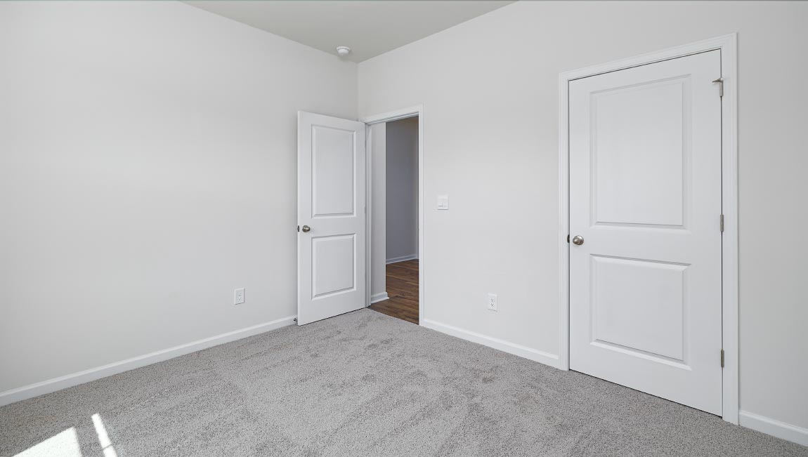 Carpeted bedroom with large window